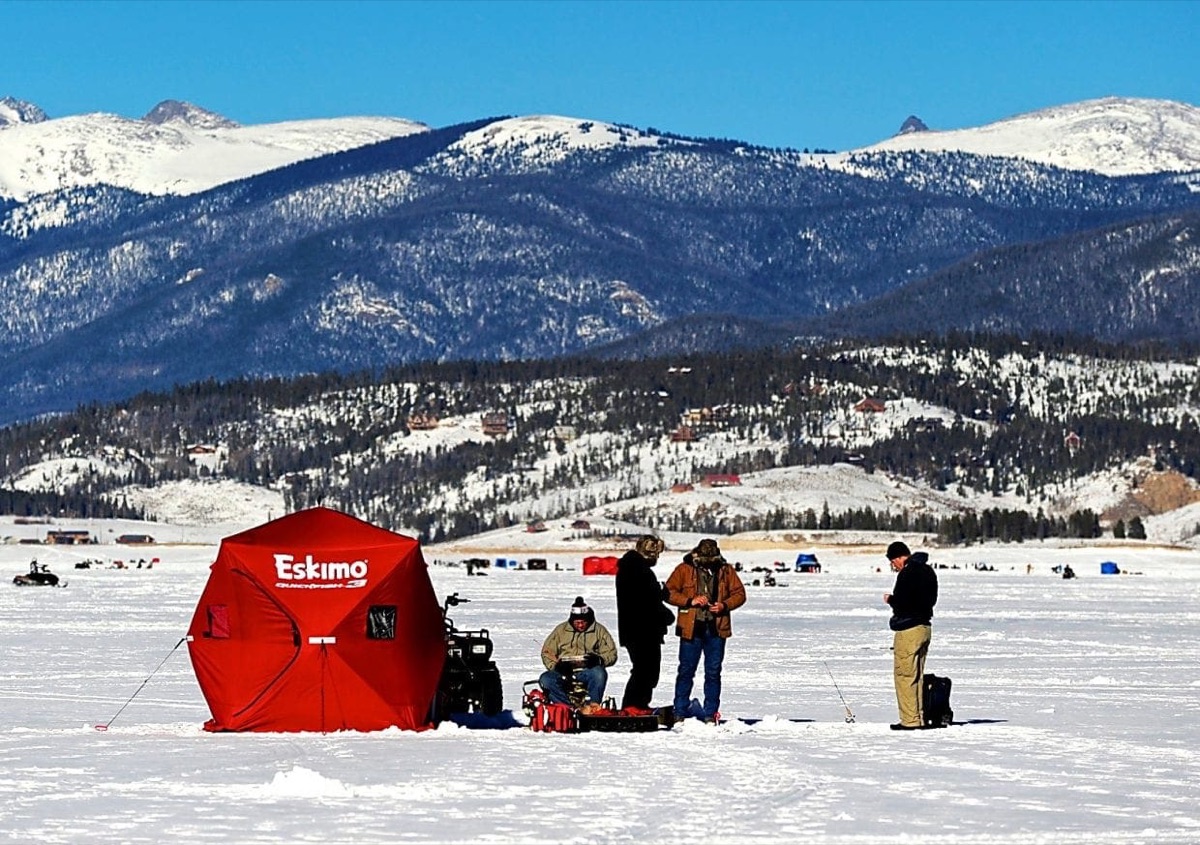 Ice fishing shelters on a frozen lake near Grand Lake