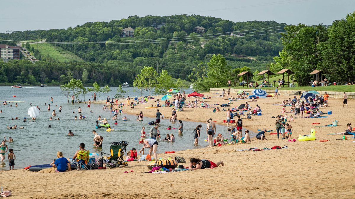Swimmers along the sandy shore at Moonshine Beach on Table Rock Lake