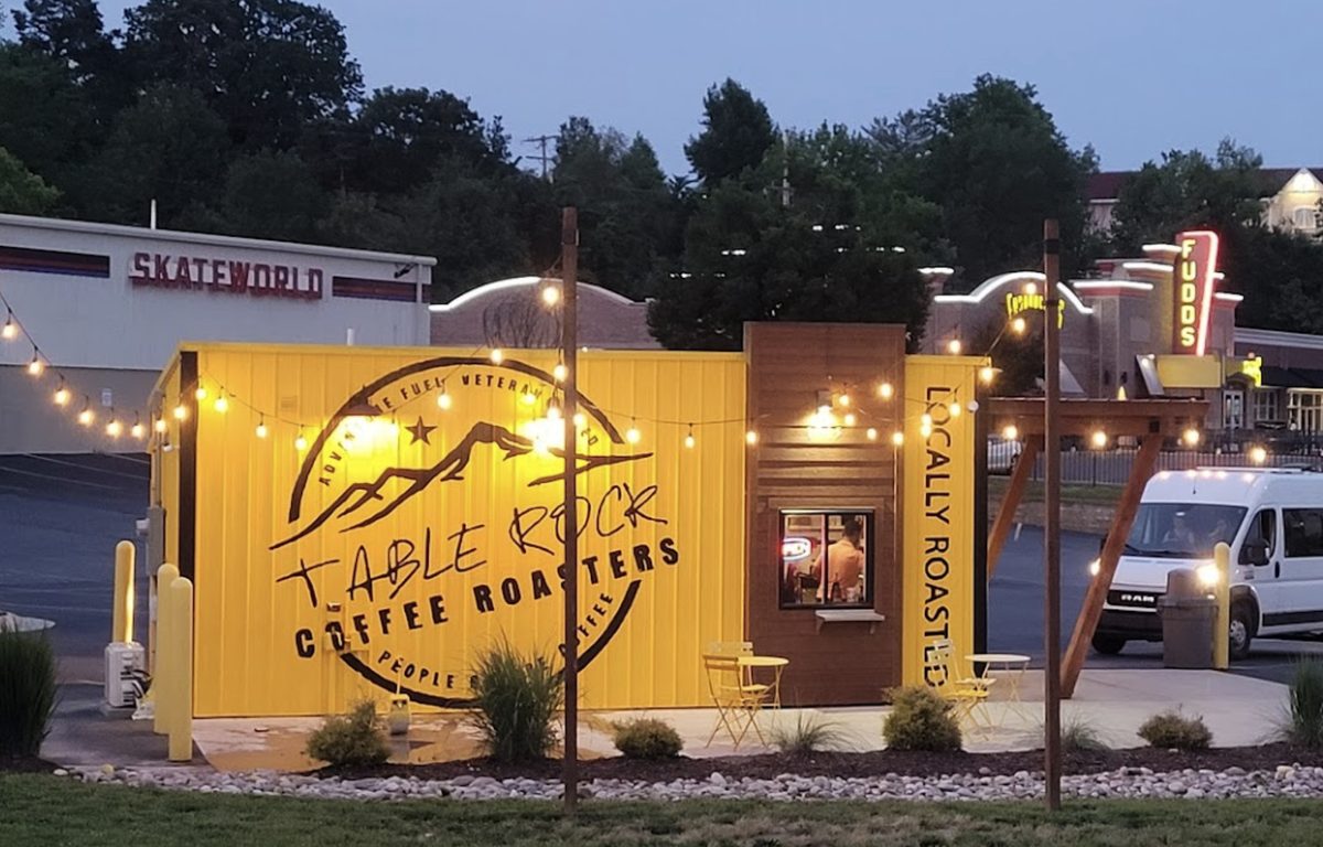 The Table Rock Coffee Roasters drive-thru lit up at dusk